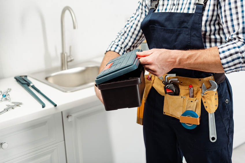 plumber with tools on tool belt