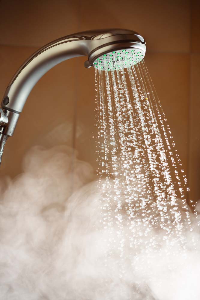 shower with flowing hot water and steam